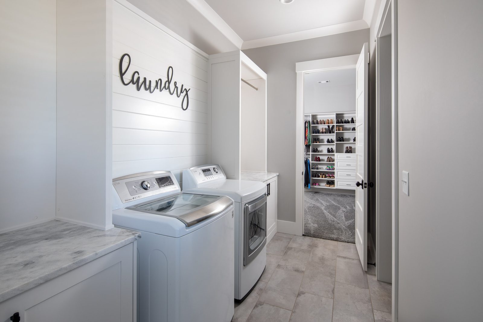 Laundry room with washer, dryer and shiplap wall — Glausier, custom home built by Ironwood Construction Group